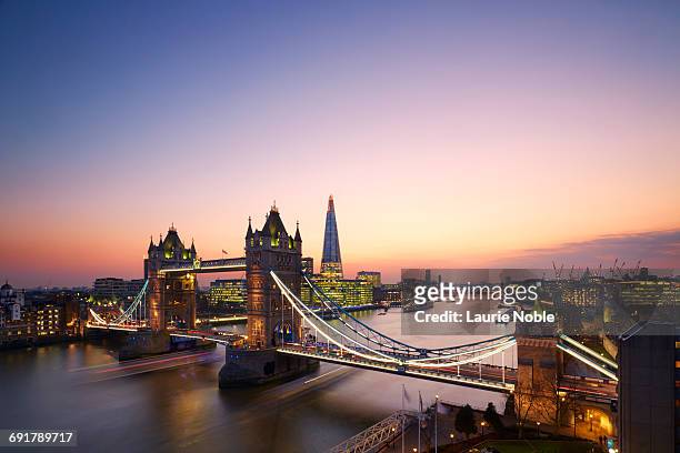 tower bridge and london skyline at sunset. - london skyline photos et images de collection
