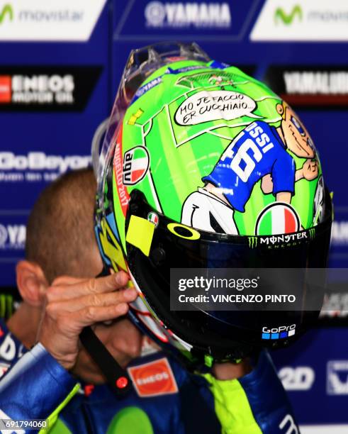 Italian Movistar Yamaha rider Valentino Rossi presents his new helmet dedicated to AS Roma football star Francesco Totti and late moto racer Nicky...