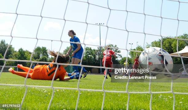 Laura Donhauser of FC Bayern Muenchen scores her sides's third goal against Julia Kassen of SV Meppen during the B Junior Girl's German Championship...