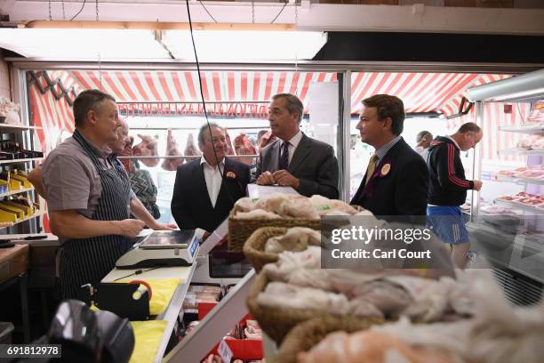 Former UKIP leader Nigel Farage and Tim Aker, UKIP candidate for Thurrock , visit a butchers as they campaign ahead of the general election on June...