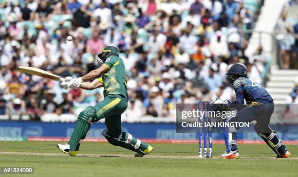 South Africa's AB de Villiers plays the shot, caught by Sri Lanka's Chamara Kapugedera, to lose his wicket for four during the ICC Champions Trophy...