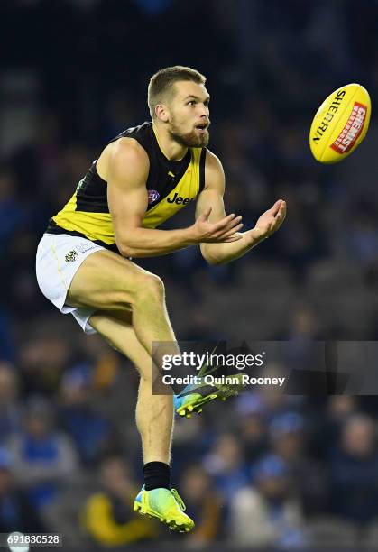 Dan Butler of the Tigers marks during the round 11 AFL match between the North Melbourne Kangaroos and the Richmond Tigers at Etihad Stadium on June...