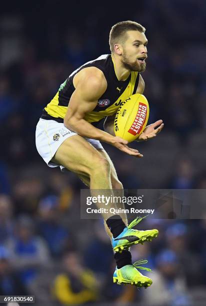 Dan Butler of the Tigers marks during the round 11 AFL match between the North Melbourne Kangaroos and the Richmond Tigers at Etihad Stadium on June...