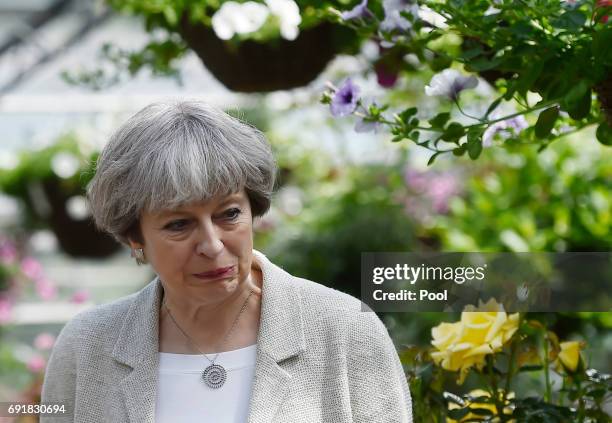 Britain's Prime Minister Theresa May reacts during an election campaign visit to Horsfields Nursery on June 3, 2017 in Silkstone, South Yorkshire,...