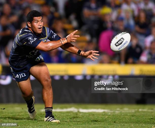 John Asiata of the Cowboys passes the ball during the round 13 NRL match between the North Queensland Cowboys and the Gold Coast Titans at 1300SMILES...