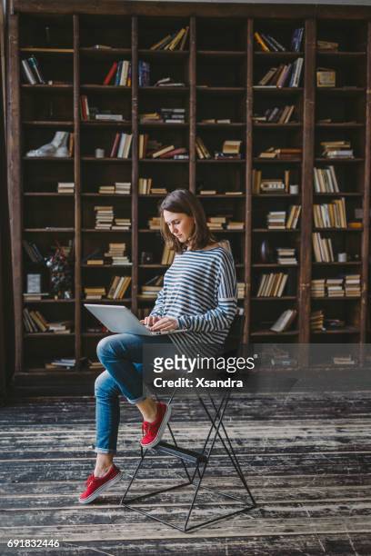 young woman studying in the library - author stock pictures, royalty-free photos & images