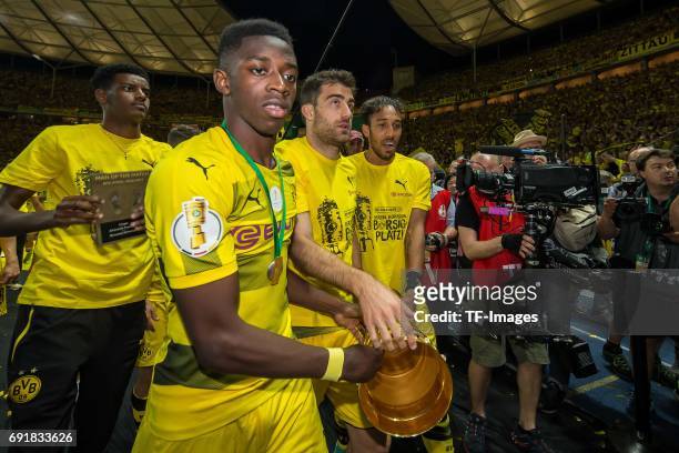 Ousmane Dembele of Dortmund, Sokratis of Dortmund and Pierre-Emerick Aubameyang of Dortmund celebrates with the trophy after winning the DFB Cup...