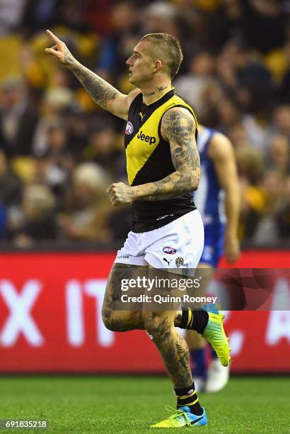 Dustin Martin of the Tigers celebrates kicking a goal during the round 11 AFL match between the North Melbourne Kangaroos and the Richmond Tigers at...