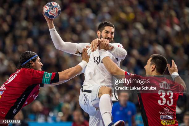 Nikola Karabatic is attacked by Laszlo Nagy and Renato Sulic of Veszprem during the VELUX EHF FINAL4 Semi Final match between Telekom Veszprem and...