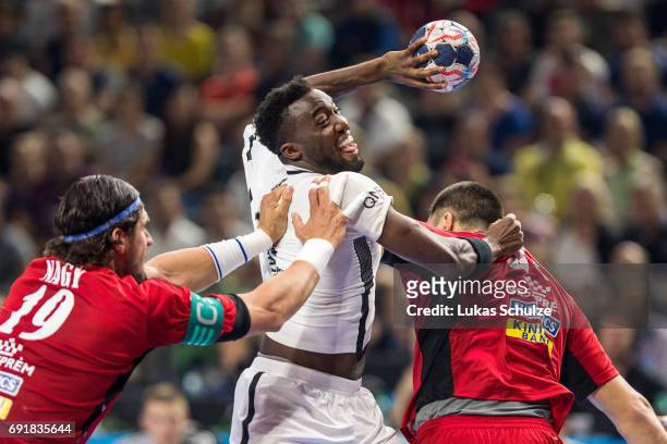 Luc Abalo of Paris is attacked by Laszlo Nagy of Veszprem during the VELUX EHF FINAL4 Semi Final match between Telekom Veszprem and Paris...