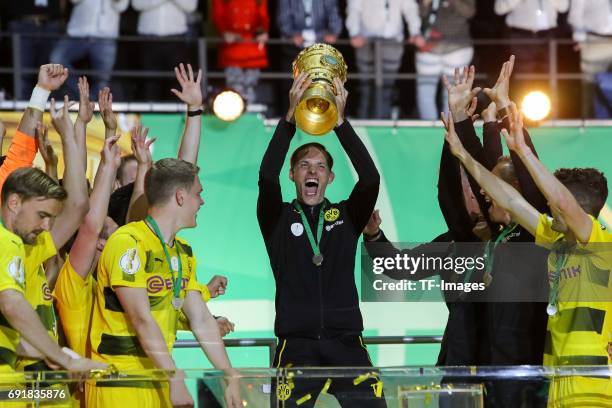 Head coach Thomas Tuchel of Dortmund celebrates with the trophy after winning the DFB Cup final match between Eintracht Frankfurt and Borussia...