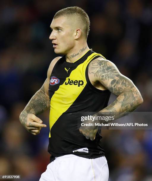 Dustin Martin of the Tigers points to his jumper during the 2017 AFL round 11 match between the North Melbourne Kangaroos and the Richmond Tigers at...