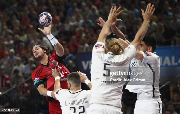 Laszlo Nagy vv is challenged by Luka Karabatic of Paris during the VELUX EHF FINAL4 Semi Final between Telekom Veszprem and Paris Saint-Germain...