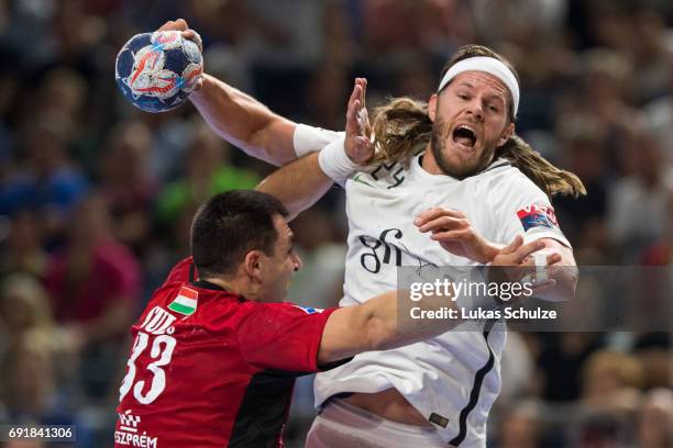 Mikkel Hansen of Paris is attacked by Renato Sulic of Veszprem during the VELUX EHF FINAL4 Semi Final match between Telekom Veszprem and Paris...