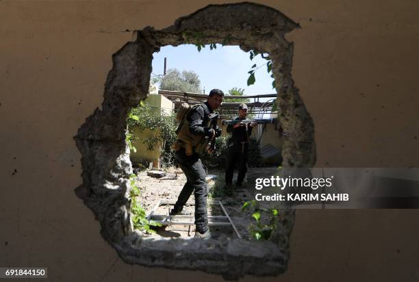 Iraqi Counter-Terrorism Services secure a house near the old city in west Mosul on June 3 during the ongoing offensive to retake the city from...