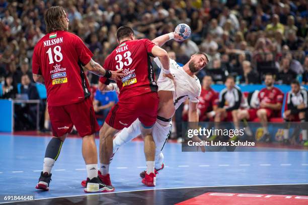 Luka Karabatic of Paris is attacked by Andreas Nilsson and Renato Sulic of Veszprem during the VELUX EHF FINAL4 Semi Final match between Telekom...