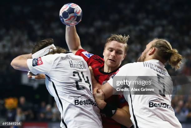 Aron Palmarsson of Veszprem is challenged by Mikkel Hansen and Henrik Mollgaard Jensen of Paris during the VELUX EHF FINAL4 Semi Final between...