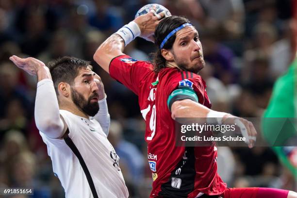 Laszlo Nagy of Veszprem is attacked by Nikola Karabatic of Paris during the VELUX EHF FINAL4 Semi Final match between Telekom Veszprem and Paris...