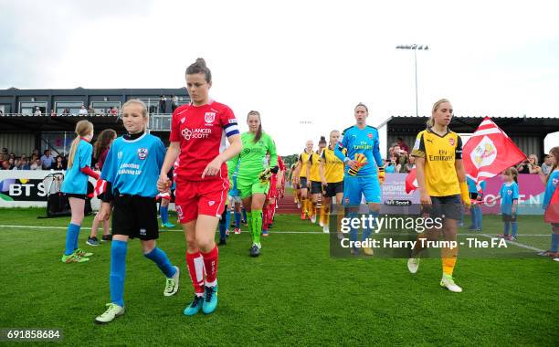 Members of both sides walk out for the start during the WSL 1 match between Bristol City Women and Arsenal Ladies at the Stoke Gifford Stadium on...