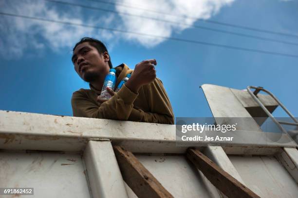 Resident who escaped from the inner city being sieged by militants clutching bottles of water, on June 3, 2017 in Marawi City, southern Philippines....