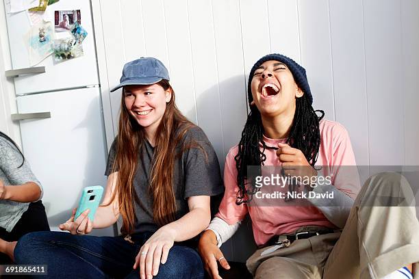 girl friends hanging out together - lachen stockfoto's en -beelden