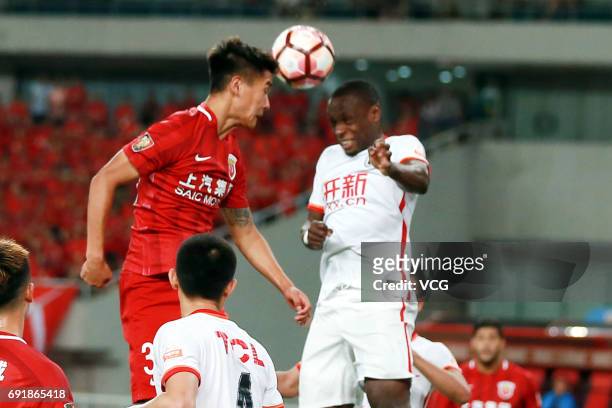 Wei Shihao of Shanghai SIPG and Anthony Ujah of Liaoning Whowin head the ball during the 12th round match of 2017 Chinese Football Association Super...