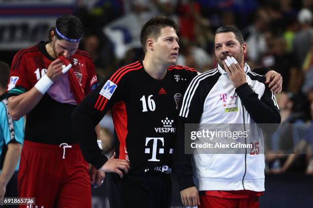 Jose Maria Rodriguez Vaquero, Roland Mikler and Laszlo Nagy of Veszprem react after the VELUX EHF FINAL4 Semi Final between Telekom Veszprem and...