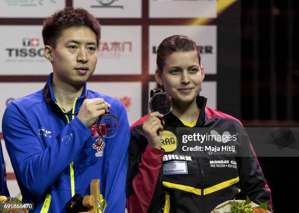 Fang Bo of China and Petrissa Solja of Germany pose with a bronze medal during celebration ceremony after Mixed Doubles Finals at Table Tennis World...