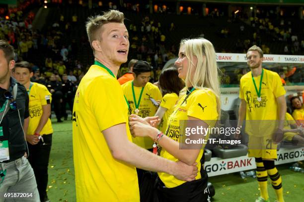 Marco Reus of Dortmund and his girlfriend Scarlett Gartmann looks on during the DFB Cup final match between Eintracht Frankfurt and Borussia Dortmund...