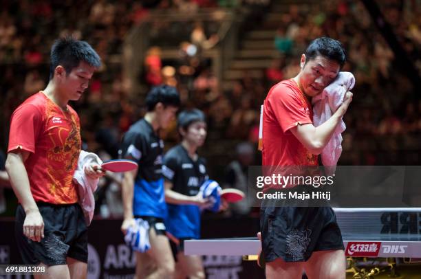 Zhendong Fan of China and Xin Xu of China leave after winning Men's Doubles Semi-Finals against Koki Niwa of Japan and Maharu Yoshimura of Japan at...