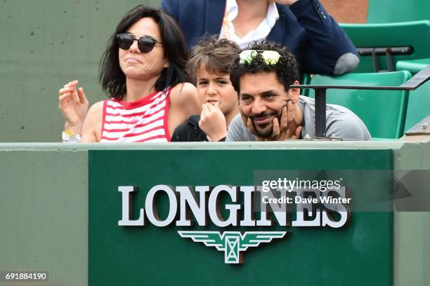 French actor Tomer Sisley with his partner Sandra Zeitoun de Matteis during day 7 of the French Open at Roland Garros on June 3, 2017 in Paris,...