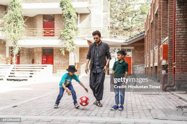 Bollywood actor Irrfan Khan posing with kids during an exclusive shoot for Hindustan Times' "Paathshala", an initiative that supports and funds the...