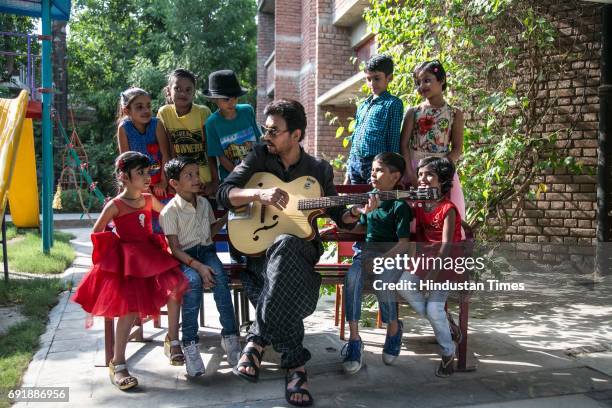 Bollywood actor Irrfan Khan posing with kids during an exclusive shoot for Hindustan Times' "Paathshala", an initiative that supports and funds the...