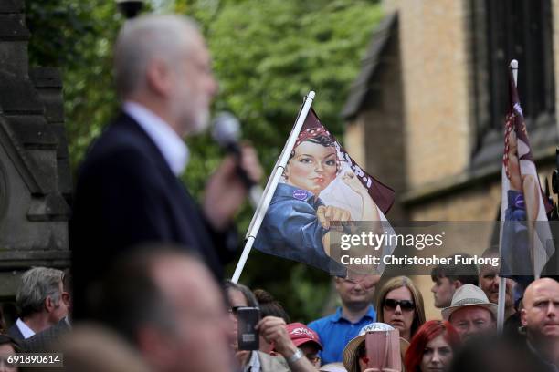 Copies of the 'We Can Do It' poster adorn some flags held up by supporters as Labour leader Jeremy Corbyn addresses a rally of supporters at Hucknall...