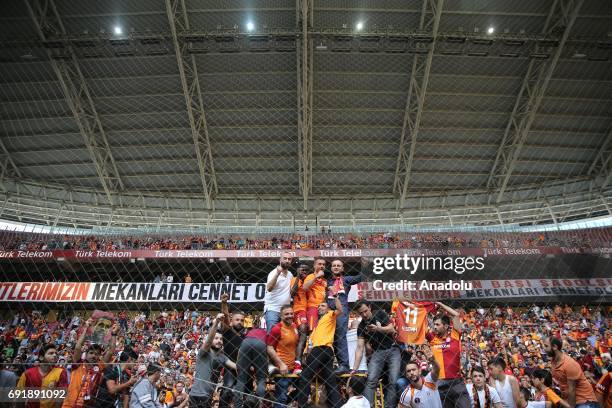 Lukas Podolski of Galatasaray and Bruma pose for a photo with fans after the Turkish Spor Toto Super Lig match between Galatasaray and Atiker...