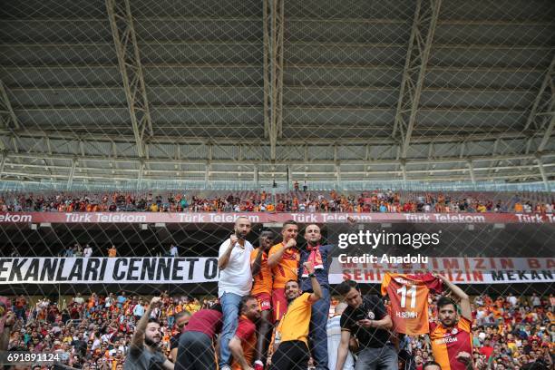 Lukas Podolski of Galatasaray and Bruma pose for a photo with fans after the Turkish Spor Toto Super Lig match between Galatasaray and Atiker...