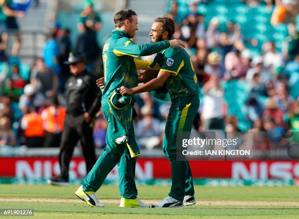 South Africas Imran Tahir celebrates with South Africas Captain AB de Villiers after winning the ICC Champions Trophy match between South Africa and...