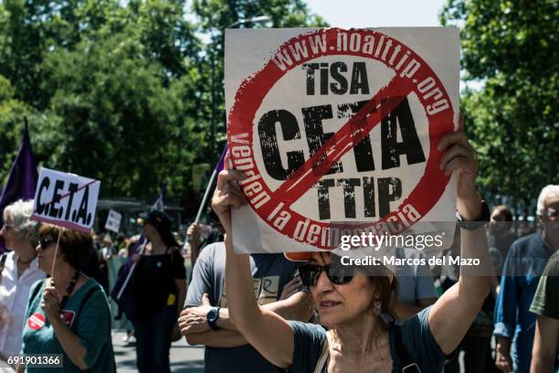 Woman protesting with a placard against CETA trade deal during a demonstration demanding Spanish government not to ratify trade agreement between...