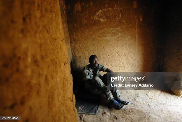 Sudanese government soldiers sit in a prison in Iriba, in northeastern Chad, October 14, 2006. Fierce fighting continues between Sudanese government...