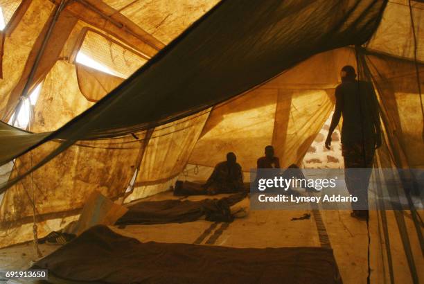 Sudanese government soldiers sit wounded in a local hospital in Iriba, in northeastern Chad, October 14, 2006. Fierce fighting continues between...