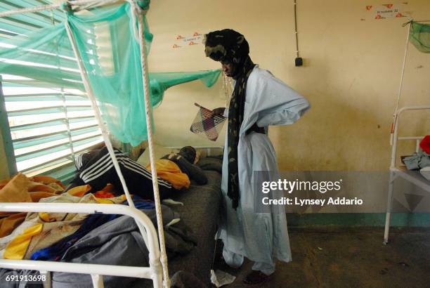 Darfur rebel fans a wounded commrade in a local hospital in Iriba, in northeastern Chad, October 14, 2006. Fierce fighting continues between Sudanese...