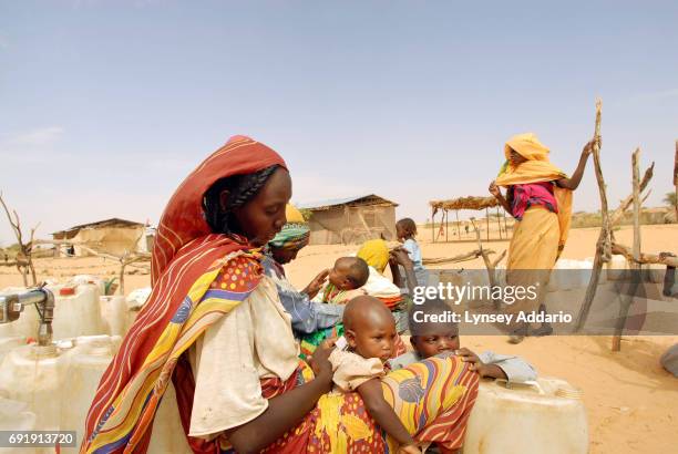 Sudanese refugees gather at a water point in Touloum camp in northeastern Chad, October 15, 2006. Chad, with its very limited supply of natural...