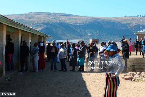 Voters queue to cast their ballot at a polling station on June 3, 2017 in Maseru, Lesotho, during Lesotho's general election. Voters in the small...