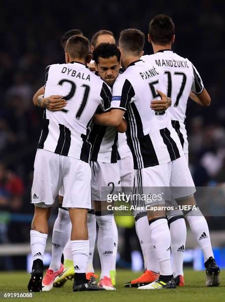 Dani Alves of Juventus, Paulo Dybala of Juventus and Miralem Pjanic of Juventus embrace prior to the UEFA Champions League Final between Juventus and...