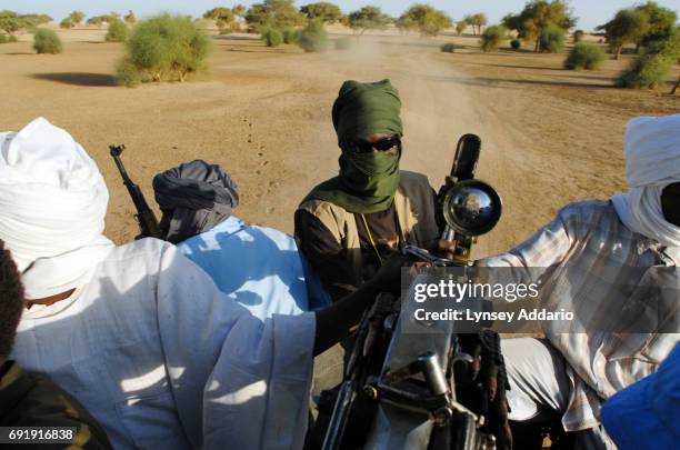 Truck of Sudanese rebels with the NRF ride along the Chad Darfur border as they head towards a former Sudanese government military camp where the...