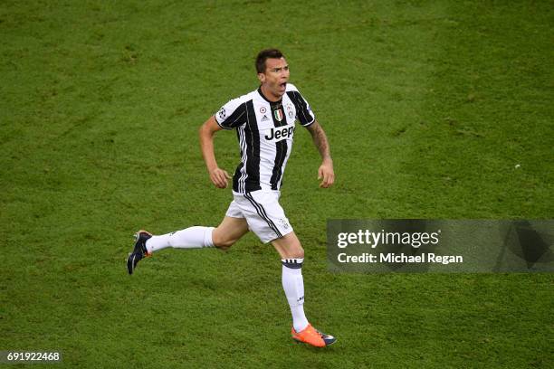 Mario Mandzukic of Juventus celebrates scoring his sides first goal during the UEFA Champions League Final between Juventus and Real Madrid at...