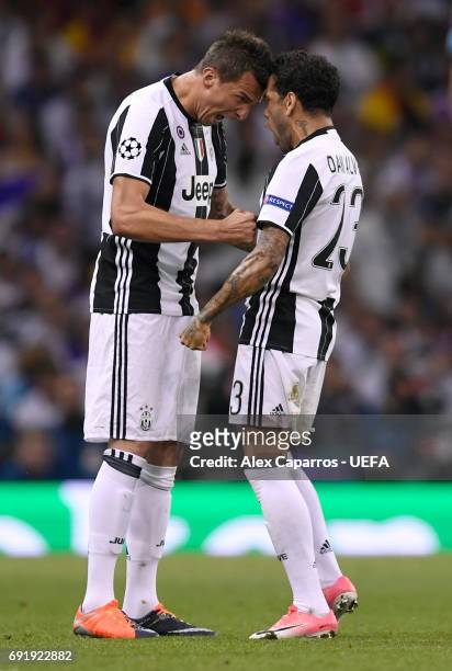 Mario Mandzukic of Juventus celebrates scoring his sides first goal with Dani Alves of Juventus during the UEFA Champions League Final between...