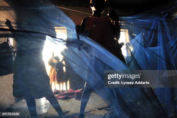 Southern Sudanese orphans hang bug nets in their room in the Cornerstone Children's Home in Nimule, South Sudan, February 2008. Thousands of children...
