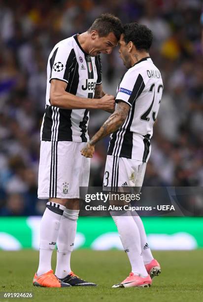 Mario Mandzukic of Juventus celebrates scoring his sides first goal with Dani Alves of Juventus during the UEFA Champions League Final between...