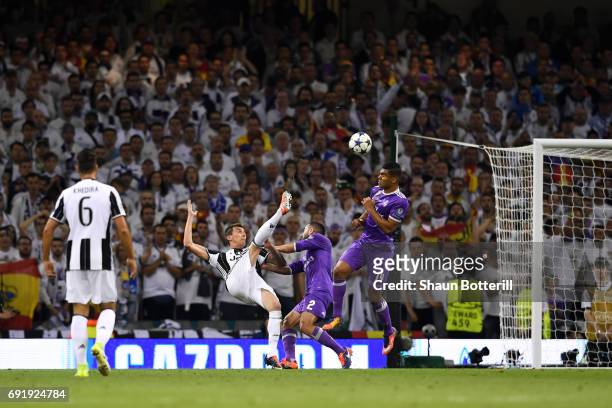 Mario Mandzukic of Juventus scores his sides first goal during the UEFA Champions League Final between Juventus and Real Madrid at National Stadium...